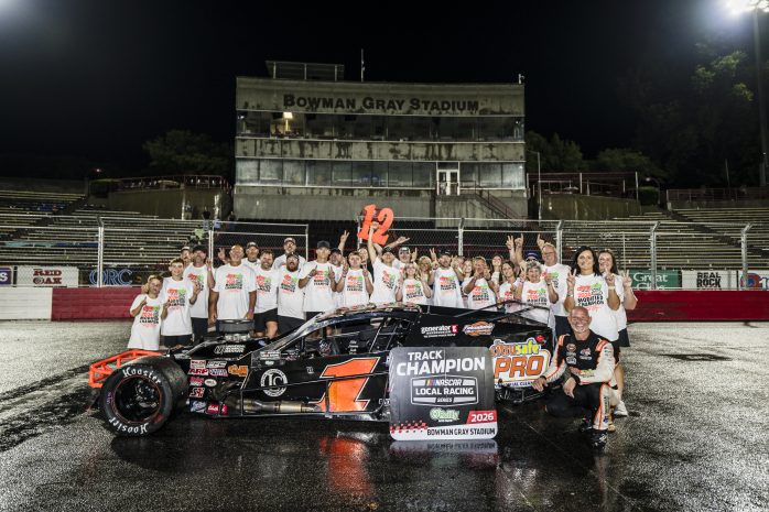 Burt Myers poses with his family, friends and crews on the frontstretch after winning his 12th Modified Championship